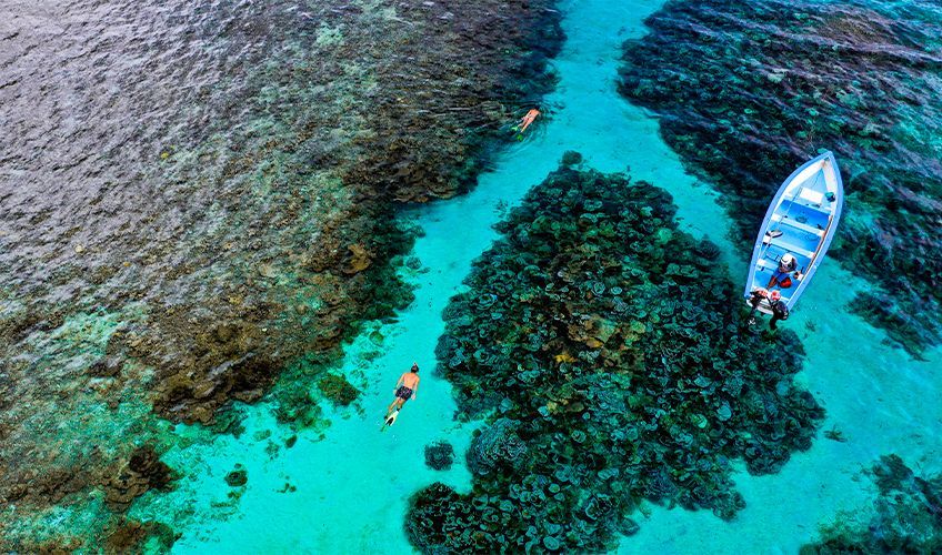 bateau et personnes faisant du snorkeling dans le lagon de rodrigues